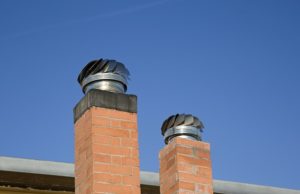 Two Chimney Caps with blue sky as background